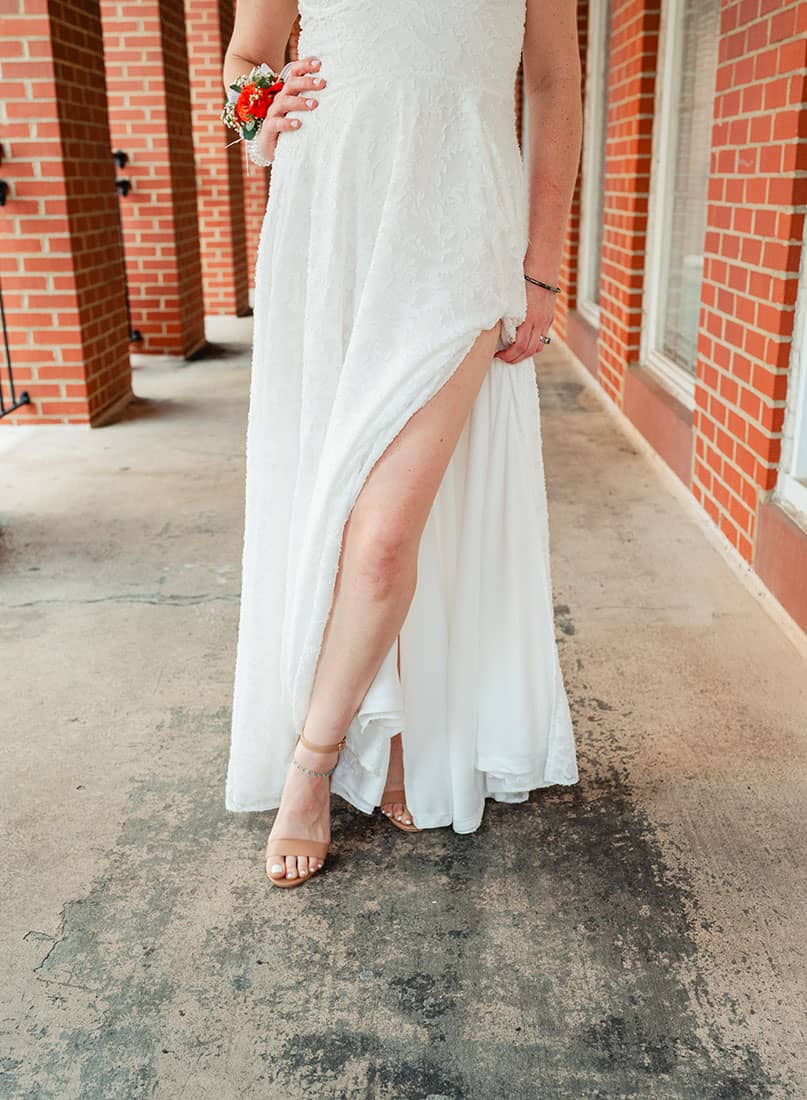 close up of brides legs in wedding dress