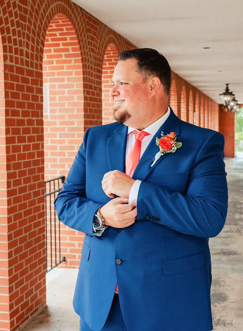 groom looking to the side and smiling