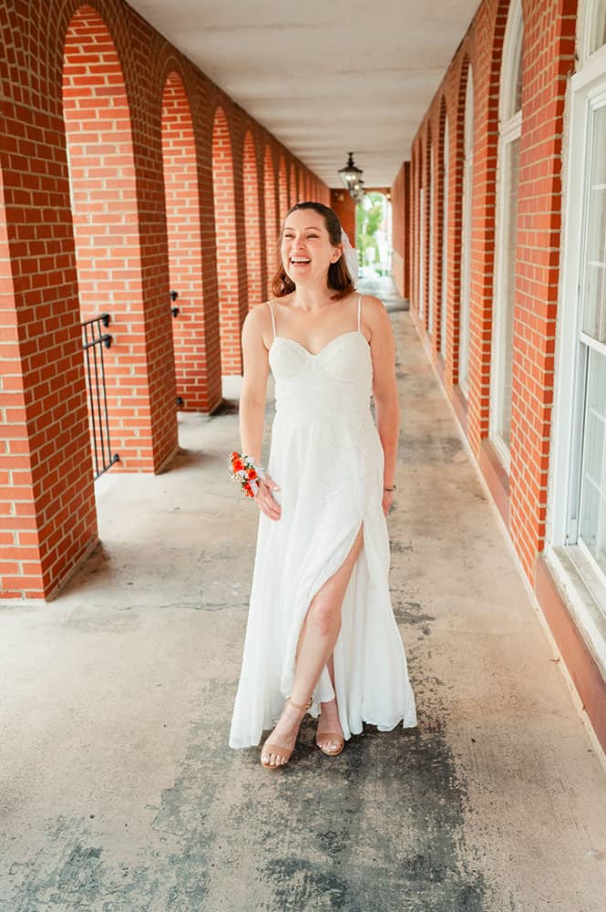 bride standing outside near brick walls