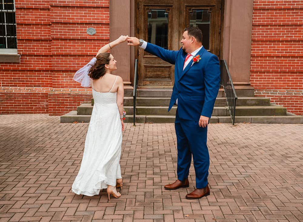 bride and groom dancing outside