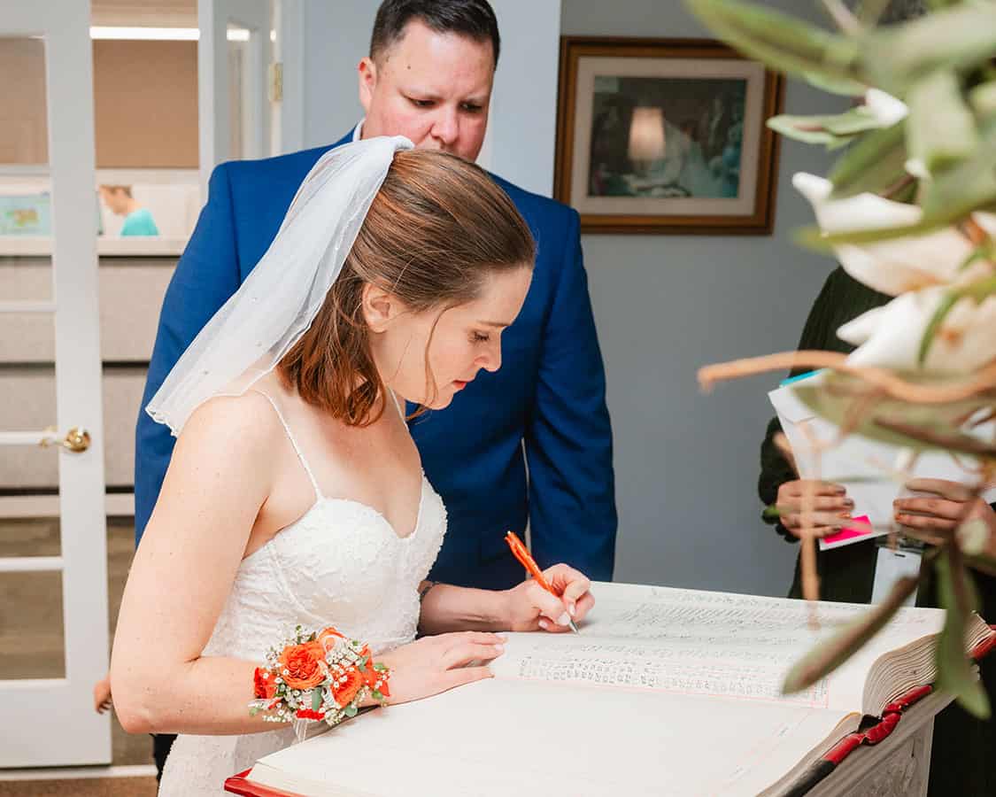 bride and groom signing courthouse book