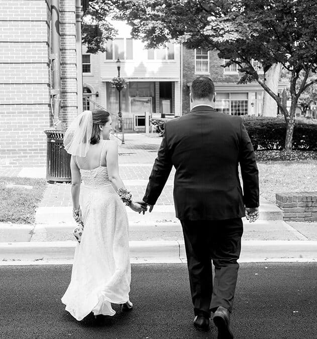 bride and groom walking on street after Maryland courthouse wedding