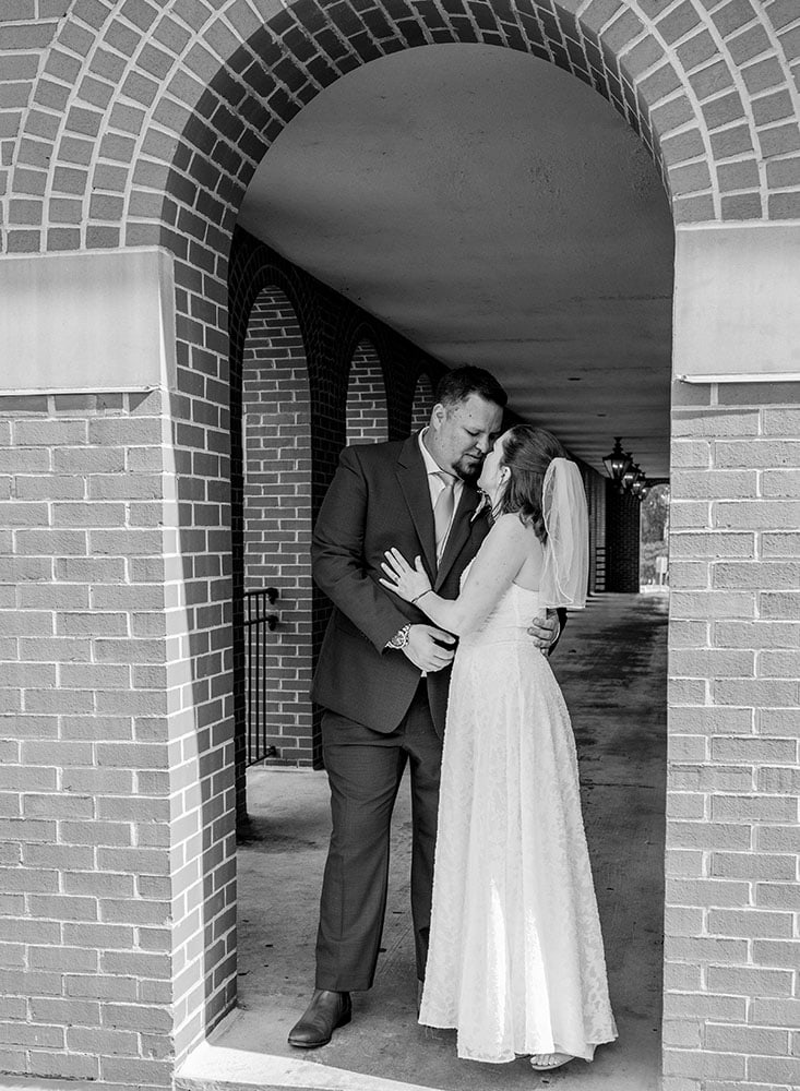 black and white photo of bride and groom outside