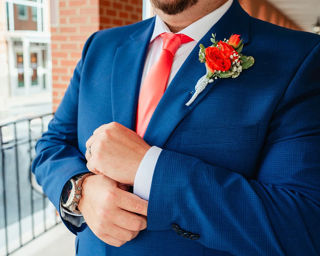 close up photo of grooms tie and suit