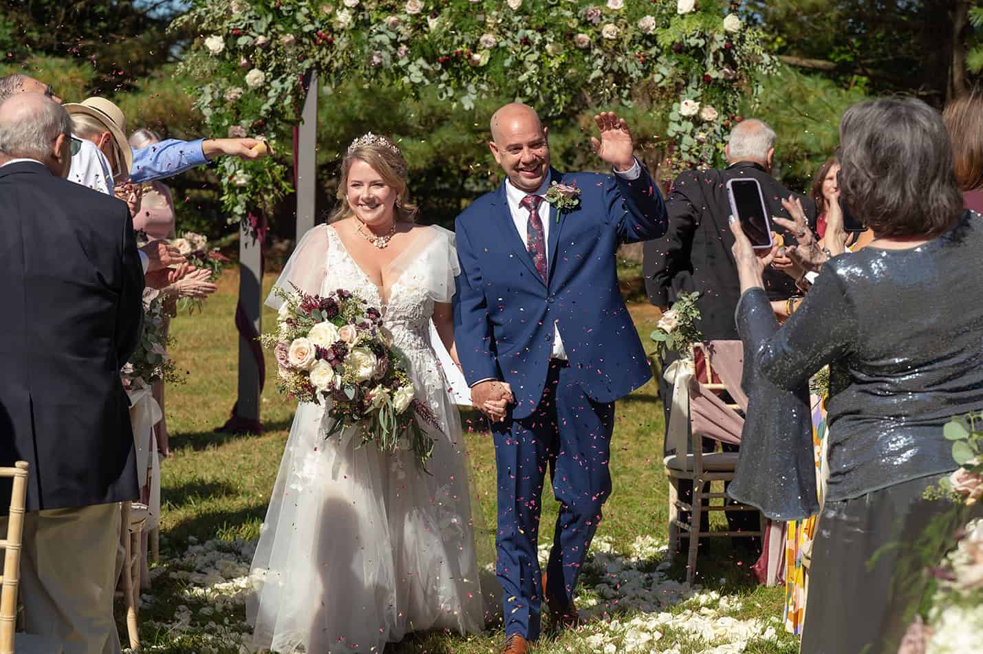 bride and groom with flower petals thrown wedding photography in maryland